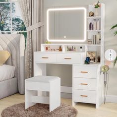 a white vanity with lighted mirror and stool in front of a window, next to a bed