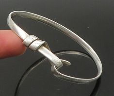 "GAETAN 925 Sterling Silver - Vintage Shiny Loop Hook Bangle Bracelet - BT8885  Jewelry Type:         Bracelet  Metal Type:            925 Silver  Metal Size:             6.5\"   Stone Type:            N/A  Condition:              N/A  Jewelry Weight:     14.2 Grams  PLEASE NOTE: THIS ITEM IS PRE-OWNED. ALTHOUGH MOST ITEMS ARE IN VERY GOOD CONDITION, SOME MAY NEED CLEANING AND/OR MINOR REPAIRS. WE MAKE A VERY STRONG EFFORT TO UPLOAD CLEAR PICTURES. PLEASE INSPECT ALL PICTURES AND ASK ALL QUESTIONS YOU MAY HAVE PRIOR TO MAKING A PURCHASE. NOT ALL STONES ARE GENUINE, SOME ARE ENHANCED OR CREATED." Metal Bracelets, Types Of Metal, Metallic Silver, Bangle Bracelets, 925 Silver, Bangles, Bracelet, 925 Sterling Silver, Sterling Silver