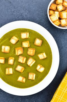 a bowl of soup with tofu cubes in it