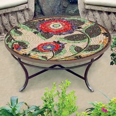 a mosaic table sitting on top of a patio