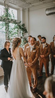 a bride and groom standing in front of their guests