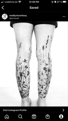 a person with tattoos on their legs standing in front of a white background and black and white photo