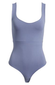 A sleek curve-hugging bodysuit featuring a dipped neckline and low U-back. Stretch fit Built-in shelf bra Snap gusset closure Thong cut 92% nylon, 8% elastane Machine wash, dry flat Imported Nylon Bodysuit With Built-in Bra And Scoop Neck, Summer Shaping Bodysuit, Bra Friendly, Nylon Smoothing Scoop Neck Bodysuit, Shaping Summer Bodysuit Bra Friendly, Scoop Neck Smoothing Nylon Bodysuit, Smoothing Nylon Scoop Neck Bodysuit, Shaping Bodysuit With Bra Friendly For Summer, Smoothing Nylon Bodysuit With Scoop Neck, Blue Seamless Bodysuit With Scoop Neck