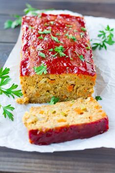 a loaf of meatloaf with ketchup and parsley