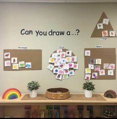 a bulletin board with post it notes and pictures on the wall next to potted plants