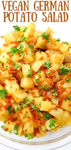 a plate filled with potato salad on top of a white tablecloth and topped with parsley