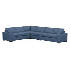 a blue sectional couch sitting on top of a white floor