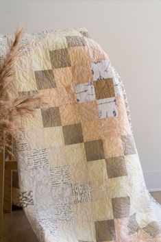 a quilted blanket sitting on top of a wooden chair