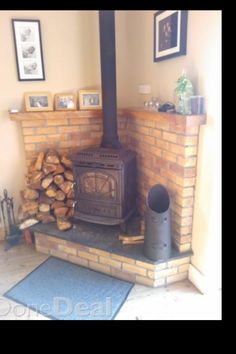 a fire place with logs stacked on the floor