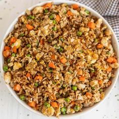 a white bowl filled with rice and vegetables