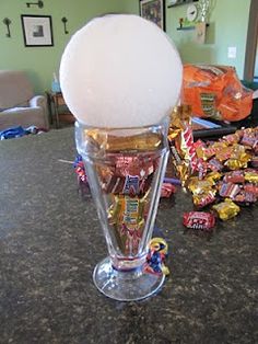 a glass filled with candy sitting on top of a counter