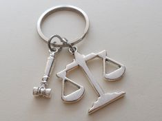 This listing is for a keychain with a law of scales charm and a gavel charm.  Great gift for lawyers, legal secretaries, paralegals, judges, and other legal professional or students. The scales charm is about 1.25 inch across.  See my other law related items here:  https://www.etsy.com/shop/JewelryEveryday?ref=seller-platform-mcnav&search_query=law Check out my other key chains for more like this: https://www.etsy.com/shop/JewelryEveryday?section_id=14577163 Paralegal Gifts, Law School Graduation Gift, Boyfriend Birthday Quotes, Gift For Graduate, Law School Inspiration, Law School Graduation, Lady Justice, Harvard Law, Harvard Law School