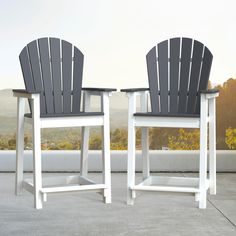 two white and black chairs sitting next to each other