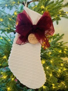 a christmas ornament hanging from the side of a tree