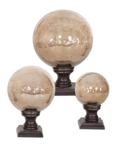 three glass globes are sitting on top of each other