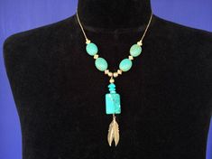 Make a statement on a tight budget...  listing is now for just one of the two... The other one in the pictures sold, so now the listing is just for the one in the solo pictures.Native American strung turquoise color beads (magnesite or Howlite) necklace with silver tone metal spacer beads & feathers... obtained at Kewa / Santo Domingo Pueblo.  each necklace hangs 12.5" long Bohemian Howlite Jewelry Gift, Bohemian Howlite Jewelry For Gifts, Bohemian Howlite Jewelry As Gift, Turquoise Feather Jewelry As Gift, Turquoise Feather Jewelry As A Gift, Adjustable Turquoise Jewelry With Feathers, Bohemian Turquoise Jewelry With Feathers, Turquoise Bohemian Jewelry With Feathers, Bohemian Howlite Beaded Necklace For Gifts