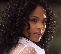 a close up of a woman with curly hair