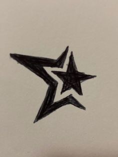 a drawing of a black star on white paper