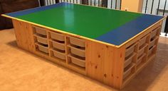 a table made out of wooden pallets with blue and green top