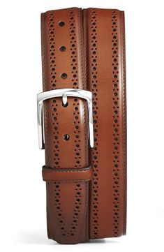 Lines of traditional two-size broguing frame this belt styled from polished fine-grain Italian leather to offer a smart finish to any formal ensemble. Leather Handcrafted in USA from imported materials