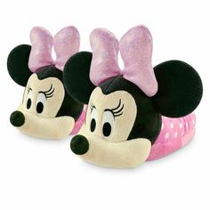 two minnie mouse slippers with pink bows on their ears and eyes, one is wearing a polka dot headband