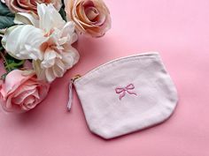 Bow Embroidered Coin Purse 🎀 See size guide in images for dimensions of the purse - message for custom colours of bow! Coin purse in the first photo is in the colour Baby Pink 🌸 - Material is 100% Organic Brushed Cotton Canvas - Purse features a zip mechanism - Design also available on sweatshirts & t-shirts, see our other listings 👇 Please read before ordering 👇 Processing time: UK dispatch between 3-7 Working Days, up to 2 weeks during busier periods Don't hesitate to contact us here or on Embroidered Pink Pouch As Gift, Embroidered Pink Pouch For Gift, Embroidered Pink Pouch For Gifts, Elegant Pink Pouch Coin Purse, Pink Embroidered Pouch For Gift, Cute Pink Coin Purse For Personal Use, Pink Coin Purse, Cute Pink Pouch Coin Purse, Pink Pouch Coin Purse With Zipper