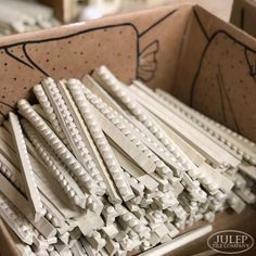 a box filled with white wooden dows on top of a table