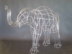 a wire sculpture of an elephant on a table