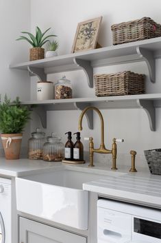 This laundry room space is part of a very special all-encompassing extension project of a beautiful historic family home in Great Brickhill, Buckinghamshire. Painted artisan shelves by Humphrey Munson have been beautifully styled to create a calm, organised corner in this well-used space.