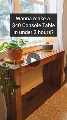 a wooden table sitting in front of a window next to a potted plant