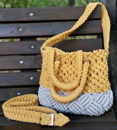 a crocheted purse sitting on top of a wooden bench