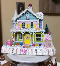 a cake that looks like a house with candy on it