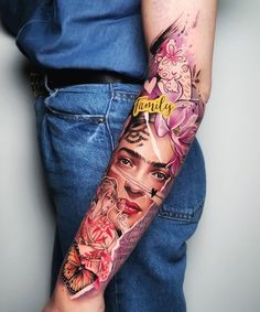 a woman's arm with tattoos and flowers on it