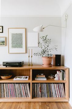 an entertainment center with record players and records