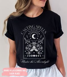 "Celestial Shirt, Spiritual Shirt, Astrology Shirt, Moon Graphic T Shirt, Mystical Moon Phase Shirt, Astrology Astronomy Moon, Graphic Shirt This comfortable T-shirt is a perfect gift idea as a birthday gift, Halloween party, or any special occasion for your best friends or your family members or anyone who you love and a really great way of putting a smile on their faces. 👕H O W TO O R D E R 1️⃣ Please, check and review all the photos. 2️⃣ Choose your T-shirt size and color. 3️⃣ Click add to c Mystical Cotton Crew Neck T-shirt, Mystical Short Sleeve Top With Graphic Print, Mystical Graphic Print Short Sleeve Top, Mystical Crew Neck Cotton T-shirt, Mystical Graphic Print Crew Neck Top, Mystical Style Cotton T-shirt With Crew Neck, Mystical Style Cotton Crew Neck T-shirt, Black Cotton Shirt With Moon Print, Mystical Graphic Print Cotton Tops