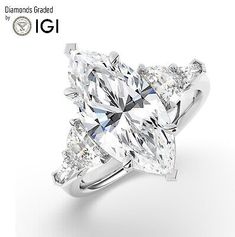 a diamond ring with three pear shaped diamonds on the side and an inscription that reads, i