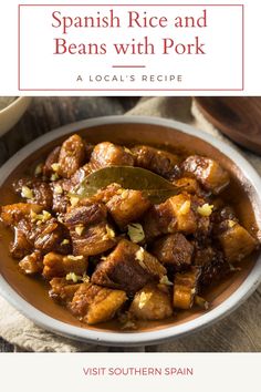 spanish rice and beans with pork recipe in a white bowl on a wooden table top