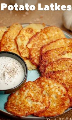 potato latkes on a blue plate with a small bowl of ranch dressing next to it