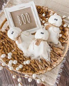 two white teddy bears sitting on top of a wicker basket next to a sign