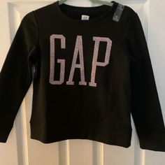 Long-Sleeved Gap In Glitter Glitter Long Sleeve Tops For Winter, Long Sleeve Glitter Tops For Winter, Long Sleeve Glitter Top For Winter, Glitter Long Sleeve Winter Tops, Winter Glitter Long Sleeve Tops, Gap Long Sleeve Top With Letter Print, Gap Tops With Letter Print For Winter, Gap Letter Print Tops For Winter, Gap Winter Tops With Letter Print