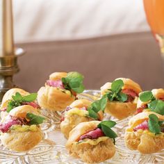 small appetizers are arranged on a glass plate