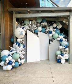 an entrance decorated with blue, white and silver balloons