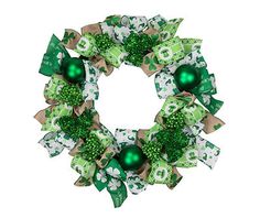 a wreath with green and white decorations on it