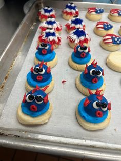 cookies decorated with red, white and blue decorations are on a baking sheet in an oven