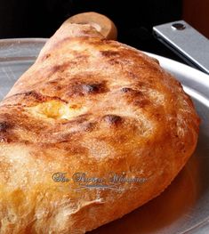 a piece of bread sitting on top of a metal plate