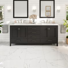 a bathroom with two sinks and mirrors on the wall