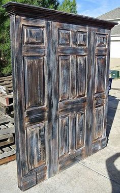 an old wooden armoire sitting on top of a sidewalk