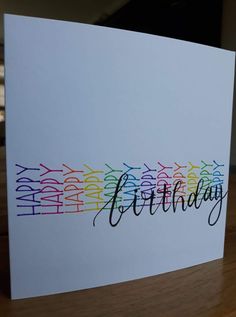 a card with the words happy birthday written in rainbow colors on it's front