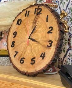 a clock sitting on top of a wooden shelf