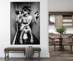 a black and white photo of a woman sitting on a toilet